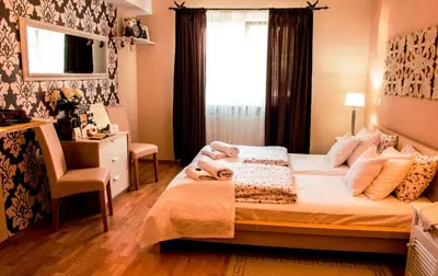 a bedroom with a bed and a desk and a window at Villa СARPE DIEM in Laško