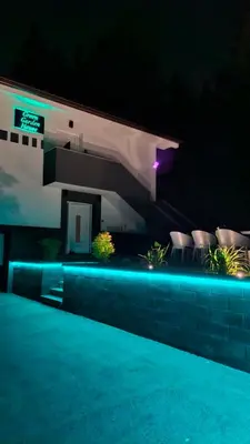 a house with a swimming pool at night at Green Garden House in Zreče