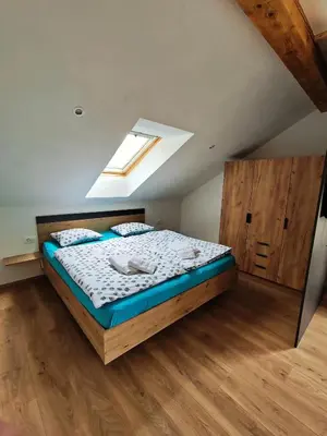 a bedroom with a bed and a skylight at Apartments and rooms pri Bašlju in Cerkno