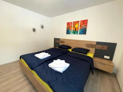 a bedroom with a bed with two towels on it at Apartments and rooms pri Bašlju in Cerkno