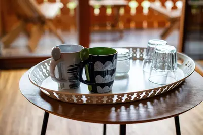 a tray with two coffee mugs on a table at Turistična kmetija Grabnar in Bled