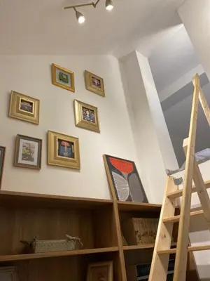 a room with a ladder and pictures on the wall at Rooms & Apartment ZALA Near Airport & Cable Car in Cerklje na Gorenjskem