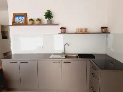 a kitchen with a sink and a counter top at Green Bee Apartment in Lesce