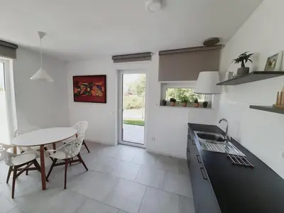 a kitchen with a table and a table and chairs at Green Bee Apartment in Lesce