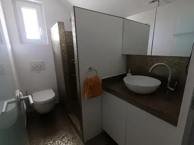a bathroom with a sink and a toilet at Hiša v mesečini - Moonlight house in Cerklje na Gorenjskem