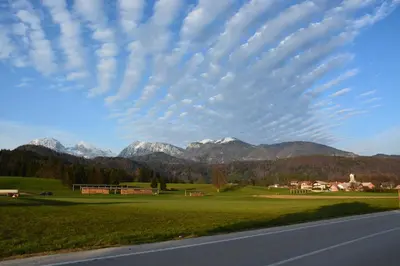 a view of a field with mountains in the background at Hiša v mesečini - Moonlight house in Cerklje na Gorenjskem