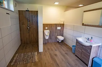 a bathroom with a shower and a sink and a toilet at Glamping Logar in Luče