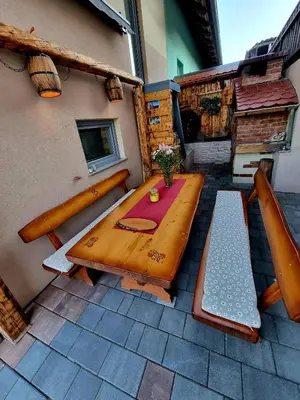 a wooden table and bench on a patio at GARTNAR HOME -Hiška s pridihom domačnosti in pogledom na hribe. in Radovljica