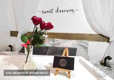 a table with a medal and a vase with red roses at The Apartment - Ljubljana in Ljubljana