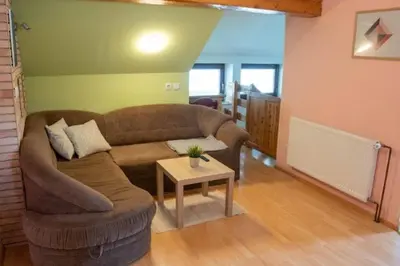 a living room with a couch and a table at Apartma Ivano in Bohinj