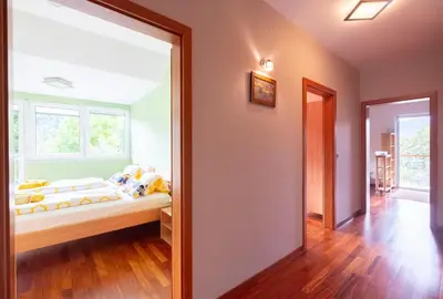 a bedroom with a bed and a large window at Apartments Apple Garden 4P in Bled