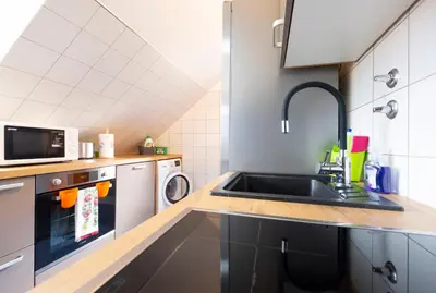 a kitchen with a sink and a microwave at Apartments Apple Garden 4P in Bled