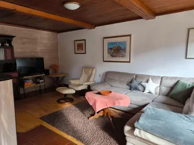a living room with a couch and a table at Hiša Jezersko in Zgornje Jezersko