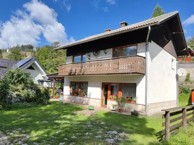 a large white house with a yard at Hiša Jezersko in Zgornje Jezersko