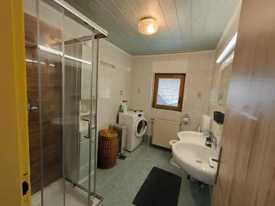 a bathroom with a shower and a sink and a toilet at Hiša Jezersko in Zgornje Jezersko