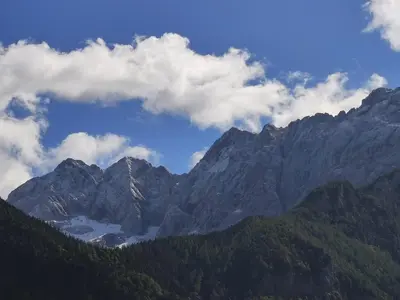 a view of a mountain range with clouds in the sky at Hiša Jezersko in Zgornje Jezersko