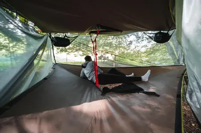 a couple is sitting in a tent at Tents resort Posestvo SONČNI RAJ in Maribor