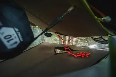 a red ribbon is on the floor of a tent at Tents resort Posestvo SONČNI RAJ in Maribor