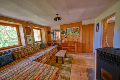 a living room with a couch and a table at Cottage surrounded by forests - The Sunny Hill in Griže