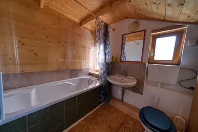a bathroom with a tub and a toilet and a sink at Cottage surrounded by forests - The Sunny Hill in Griže