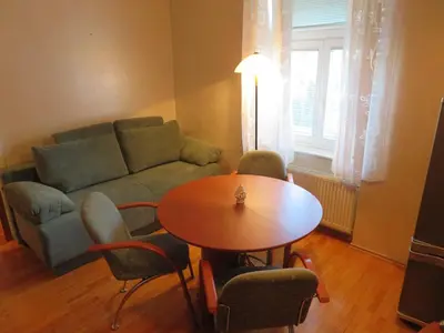 a living room with a couch and a table and chairs at Peony in Rogaška Slatina