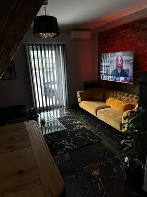a living room with a couch and a flat screen tv at NEW GUEST HOUSE 13 in Maribor