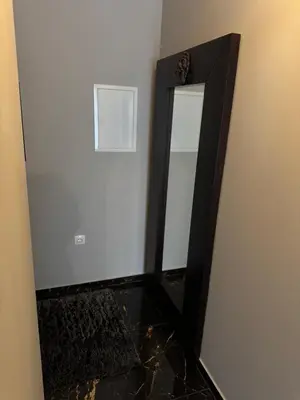 a mirror with a black frame in a room at NEW GUEST HOUSE 13 in Maribor