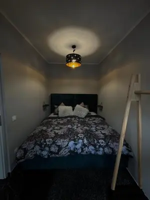 a bedroom with a bed and a light on the ceiling at NEW GUEST HOUSE 13 in Maribor