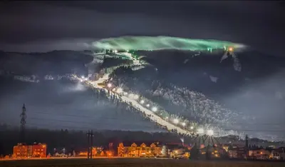 a green light on top of a mountain at night at NEW GUEST HOUSE 13 in Maribor