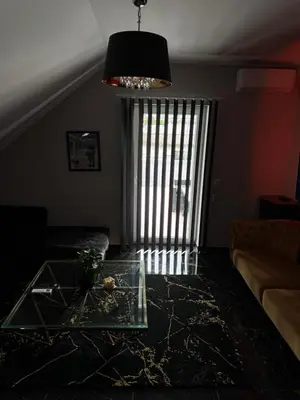 a living room with a couch and a glass table at NEW GUEST HOUSE 13 in Maribor