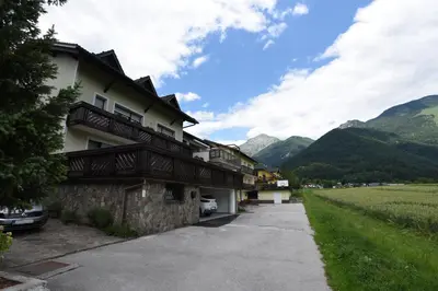 a house in the mountains with a driveway at LakeView Apartment in Preddvor