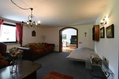 a living room with a couch and a table at LakeView Apartment in Preddvor