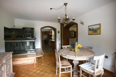 a dining room with a table and chairs and a chandelier at LakeView Apartment in Preddvor