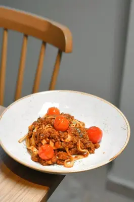a plate of food with tomatoes on a chair at Vila De Casa in Ribnica