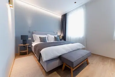 a bedroom with a large bed and a window at Vila De Casa in Ribnica