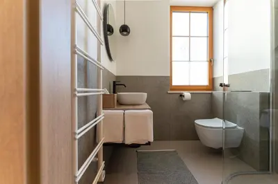 a bathroom with a toilet and a sink at Vila De Casa in Ribnica