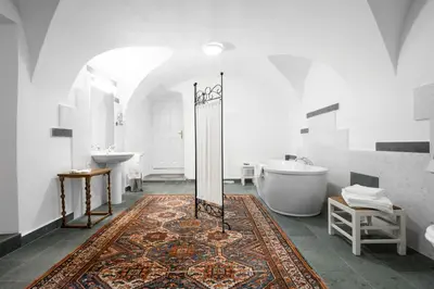 a bathroom with a tub and two sinks and a bath tub at Grad Strmol in Cerklje na Gorenjskem