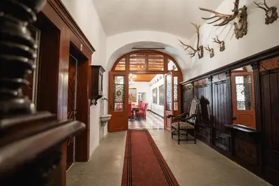 a hallway of a home with a red rug at Grad Strmol in Cerklje na Gorenjskem