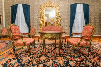 a room with two chairs and a table and a mirror at Grad Strmol in Cerklje na Gorenjskem