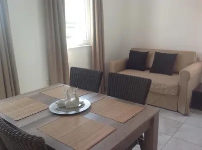 a living room with a table and chairs and a couch at Effie Perine Apartments in Bled