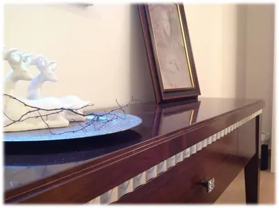 a wooden table with a plate on top of it at Effie Perine Apartments in Bled
