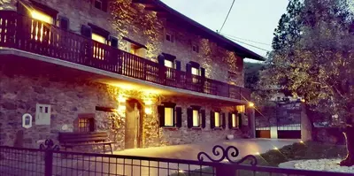 a building with a fence in front of it at Caissa - an old country lady in a new modern dress in Deskle