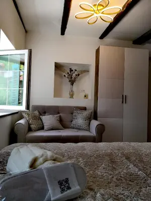 a living room with a couch and a bed at Caissa - an old country lady in a new modern dress in Deskle
