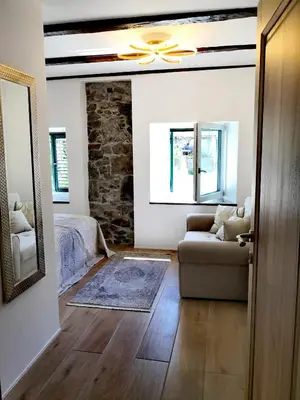a living room with a ceiling fan and a couch at Caissa - an old country lady in a new modern dress in Deskle