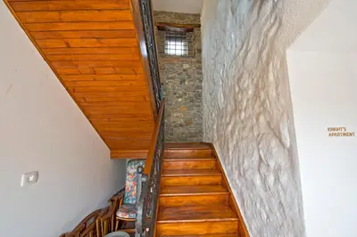 a staircase with a wooden ceiling and a window at Caissa - an old country lady in a new modern dress in Deskle