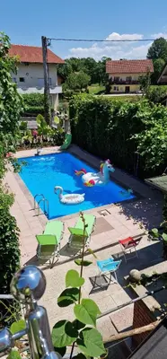 a swimming pool with chairs and people playing in it at APARTMAN MURKO P-3 in Brest