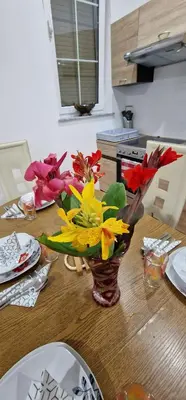 a vase of flowers on a table in a kitchen at APARTMAN MURKO P-3 in Brest