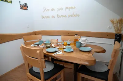a wooden table with blue dishes on it at Apartma ''Pri Movernu'' in Semič