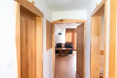 a hallway leading to a living room with a table at Apartma ''Pri Movernu'' in Semič