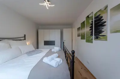 a bedroom with a bed with towels on it at TAMLiving Ljubljana 2BR Center 3 Bridges Great View Kitchen in Ljubljana